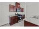 Kitchen features stainless steel appliances and dark wood cabinets at 2932 Torreon Ln, Las Vegas, NV 89121