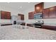 Granite countertop kitchen island with stainless steel sink and faucet at 2932 Torreon Ln, Las Vegas, NV 89121