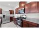 Kitchen features stainless steel appliances and dark wood cabinets at 2932 Torreon Ln, Las Vegas, NV 89121