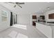 Open concept kitchen and living area with modern finishes and carpet at 2932 Torreon Ln, Las Vegas, NV 89121