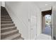 Carpeted stairway with white railing and door to exterior at 2932 Torreon Ln, Las Vegas, NV 89121