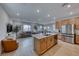 Open concept kitchen with island, stainless steel appliances, and light wood cabinets at 2986 Gallarate Dr, Henderson, NV 89044