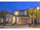 A well-maintained two-story home with a two-car garage and manicured front yard at 3213 Molinos Dr, Las Vegas, NV 89141