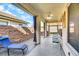 Covered back patio with comfortable seating, offering a relaxing outdoor living space at 3740 Corte Bella Hills Ave, North Las Vegas, NV 89081