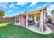 Backyard with covered patio, outdoor seating, green grass, and BBQ; perfect for entertaining guests at 3740 Corte Bella Hills Ave, North Las Vegas, NV 89081