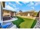Landscaped backyard with a hot tub and artificial turf at 3740 Corte Bella Hills Ave, North Las Vegas, NV 89081