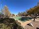 Outdoor basketball court surrounded by mature trees and grass at 3740 Corte Bella Hills Ave, North Las Vegas, NV 89081