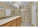 Well-lit bathroom featuring a double vanity, walk-in shower, and modern fixtures at 3740 Corte Bella Hills Ave, North Las Vegas, NV 89081