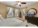 Bedroom with a ceiling fan, television and large windows at 3740 Corte Bella Hills Ave, North Las Vegas, NV 89081