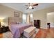 Comfortable bedroom featuring wood floors, a ceiling fan, and coordinated furniture pieces at 3740 Corte Bella Hills Ave, North Las Vegas, NV 89081