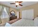 Cozy bedroom with a dresser with tv, closet, and a window for plenty of natural light at 3740 Corte Bella Hills Ave, North Las Vegas, NV 89081