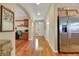 View of entryway with wood floors, office nook, stainless fridge, and neutral paint at 3740 Corte Bella Hills Ave, North Las Vegas, NV 89081