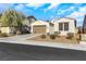 Single story home with a two car garage, low water landscaping and a desert sky at 3740 Corte Bella Hills Ave, North Las Vegas, NV 89081