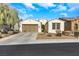Charming single-story home with a well-manicured lawn, a two-car garage and inviting curb appeal at 3740 Corte Bella Hills Ave, North Las Vegas, NV 89081