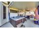 Covered hot tub with seating area and outdoor kitchen, ideal for relaxation and entertainment at 3740 Corte Bella Hills Ave, North Las Vegas, NV 89081