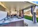 Enjoy the outdoors on this covered patio featuring a hot tub, fireplace, seating, and outdoor kitchen at 3740 Corte Bella Hills Ave, North Las Vegas, NV 89081