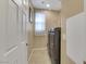 Laundry room features tile flooring, a front loading washer and dryer, and natural light at 3740 Corte Bella Hills Ave, North Las Vegas, NV 89081