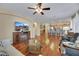 Open concept living room, hardwood floors, fireplace, ceiling fan, and neutral paint at 3740 Corte Bella Hills Ave, North Las Vegas, NV 89081