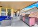 Covered patio with built-in grill, comfortable seating, and stylish decor for outdoor entertaining at 3740 Corte Bella Hills Ave, North Las Vegas, NV 89081