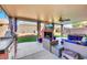 Inviting outdoor space with fireplace, TV, grill, and stylish seating area perfect for relaxing and entertaining at 3740 Corte Bella Hills Ave, North Las Vegas, NV 89081