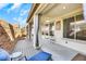 Covered patio area with ceiling fan and outdoor seating, perfect for enjoying the weather at 3740 Corte Bella Hills Ave, North Las Vegas, NV 89081