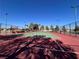 Outdoor tennis court surrounded by tall trees at 3740 Corte Bella Hills Ave, North Las Vegas, NV 89081