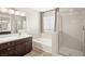 Bathroom features double vanity, soaking tub, and shower at 4712 Stable Way, North Las Vegas, NV 89032