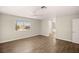 Large bedroom with wood-look floors and window view at 4712 Stable Way, North Las Vegas, NV 89032