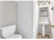 Half-bathroom with white toilet and sink at 5037 Monte Del Sol Ln, North Las Vegas, NV 89031