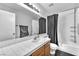Well-lit bathroom with single sink vanity, tub/shower combo, and updated fixtures at 5037 Monte Del Sol Ln, North Las Vegas, NV 89031