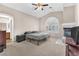 Primary bedroom with fireplace, ceiling fan, and a neutral-colored carpet at 5037 Monte Del Sol Ln, North Las Vegas, NV 89031