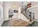 Inviting foyer featuring a winding staircase, hardwood floors, and a modern chandelier at 5037 Monte Del Sol Ln, North Las Vegas, NV 89031