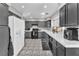 Functional kitchen with dark cabinets, white appliances, and tiled floors at 5037 Monte Del Sol Ln, North Las Vegas, NV 89031
