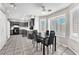 Bright kitchen and dining area with gray cabinets and modern ceiling fan and appliances at 5037 Monte Del Sol Ln, North Las Vegas, NV 89031