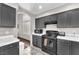 Modern kitchen with white countertops, dark cabinets, and stainless steel appliances at 5037 Monte Del Sol Ln, North Las Vegas, NV 89031
