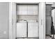 White washer and dryer in closet with white shelving at 5037 Monte Del Sol Ln, North Las Vegas, NV 89031