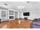 Spacious living room with hardwood floors, fireplace, and large-screen television at 5037 Monte Del Sol Ln, North Las Vegas, NV 89031