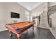 Spacious living area featuring a pool table, hardwood floors, and a view of the foyer at 5037 Monte Del Sol Ln, North Las Vegas, NV 89031