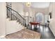 Bright living room with high ceilings, large windows, and a staircase leading to the second floor at 5037 Monte Del Sol Ln, North Las Vegas, NV 89031