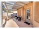 Covered patio with outdoor seating area, fire pit, and shaded space at 5037 Monte Del Sol Ln, North Las Vegas, NV 89031