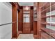 Elegant walk-in closet with custom wood shelving, drawers, and ample hanging space at 5037 Monte Del Sol Ln, North Las Vegas, NV 89031