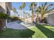 Serene backyard with a pool, manicured lawn, and mature palm trees, ideal for relaxation at 520 Summer Mesa Dr, Las Vegas, NV 89144