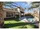Private backyard oasis featuring a sparkling pool, lush landscaping, and a covered patio at 520 Summer Mesa Dr, Las Vegas, NV 89144