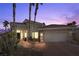 Single-story home with a two-car garage, palm trees, and a landscaped walkway at 520 Summer Mesa Dr, Las Vegas, NV 89144