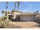 Charming single-story home with a well-maintained lawn, desert landscaping, and attached two-car garage at 520 Summer Mesa Dr, Las Vegas, NV 89144