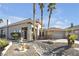 Charming single-story home with desert landscaping, a stone facade, and an attached two-car garage at 520 Summer Mesa Dr, Las Vegas, NV 89144