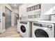 Bright laundry room with white cabinets and modern appliances at 520 Summer Mesa Dr, Las Vegas, NV 89144