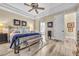 Main bedroom with king bed, ensuite bath access, and wood-look floors at 520 Summer Mesa Dr, Las Vegas, NV 89144