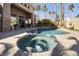 Backyard features a pool and spa surrounded by palm trees, creating a serene outdoor space at 520 Summer Mesa Dr, Las Vegas, NV 89144