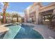 A private pool with stone surround and a covered patio make this backyard an oasis at 520 Summer Mesa Dr, Las Vegas, NV 89144
